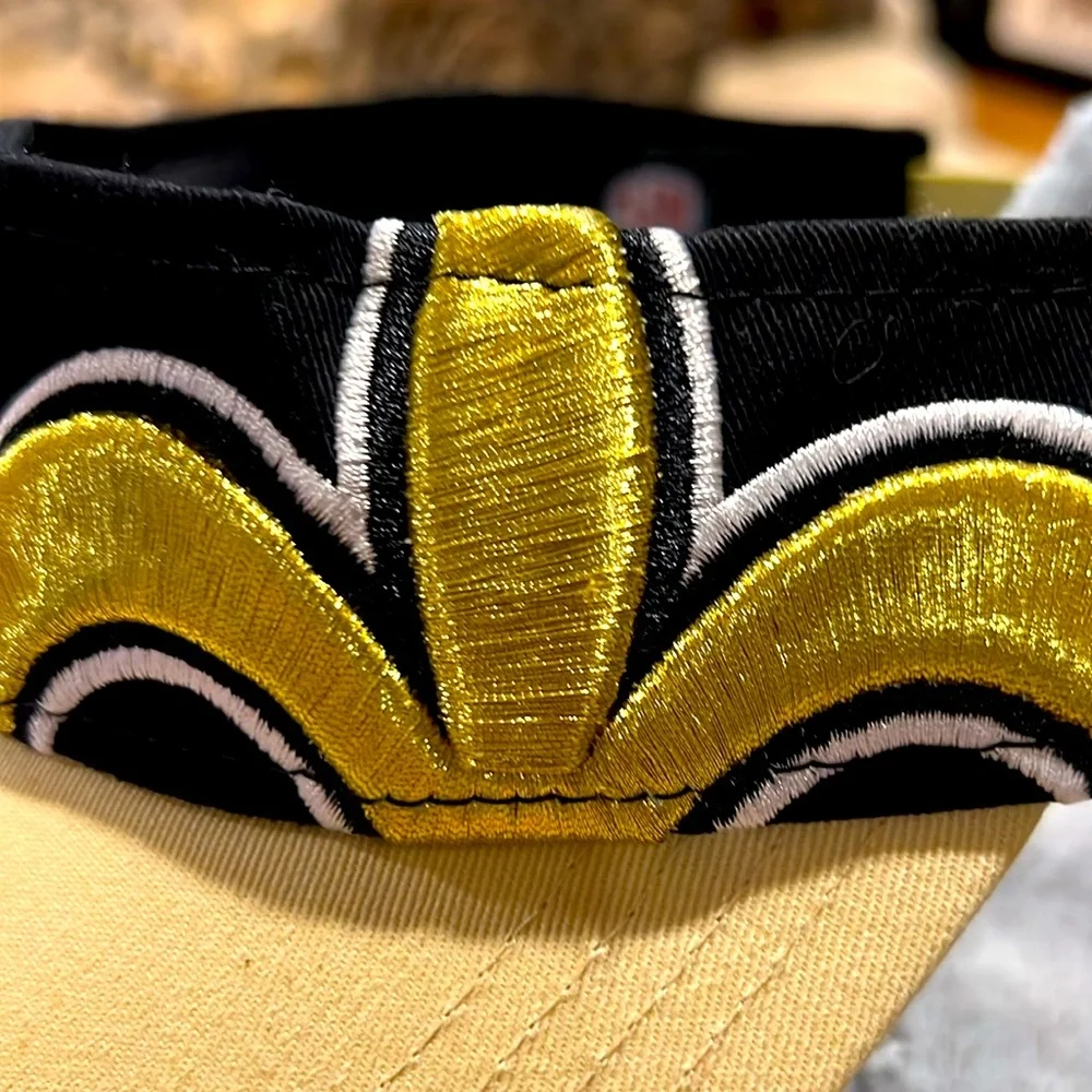 NFL Store. Saints Fleur De Lis Black and Gold. NWOT Visor. Adjustable.